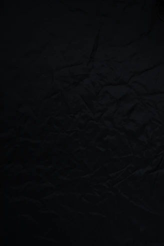 black textile on brown wooden table