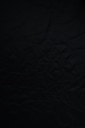 black textile on brown wooden table