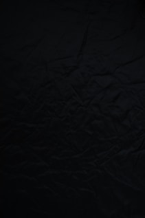 black textile on brown wooden table