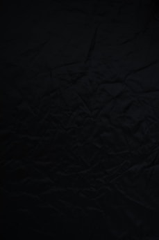 black textile on brown wooden table