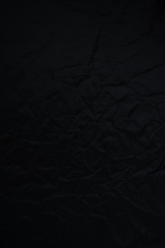 black textile on brown wooden table