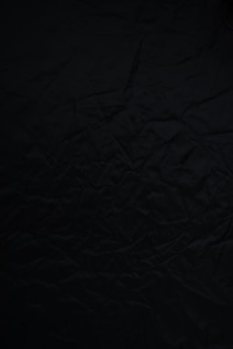 black textile on brown wooden table