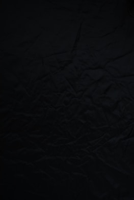 black textile on brown wooden table