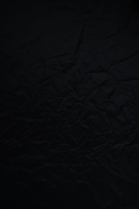 black textile on brown wooden table