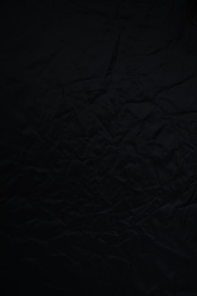 black textile on brown wooden table