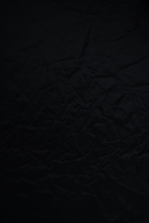 black textile on brown wooden table