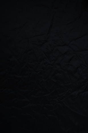 black textile on brown wooden table