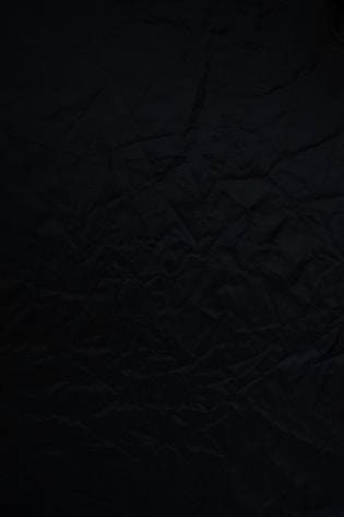 black textile on brown wooden table