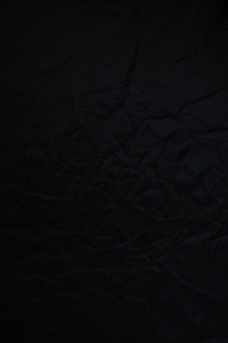 black textile on brown wooden table