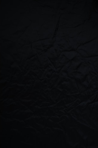 black textile on brown wooden table