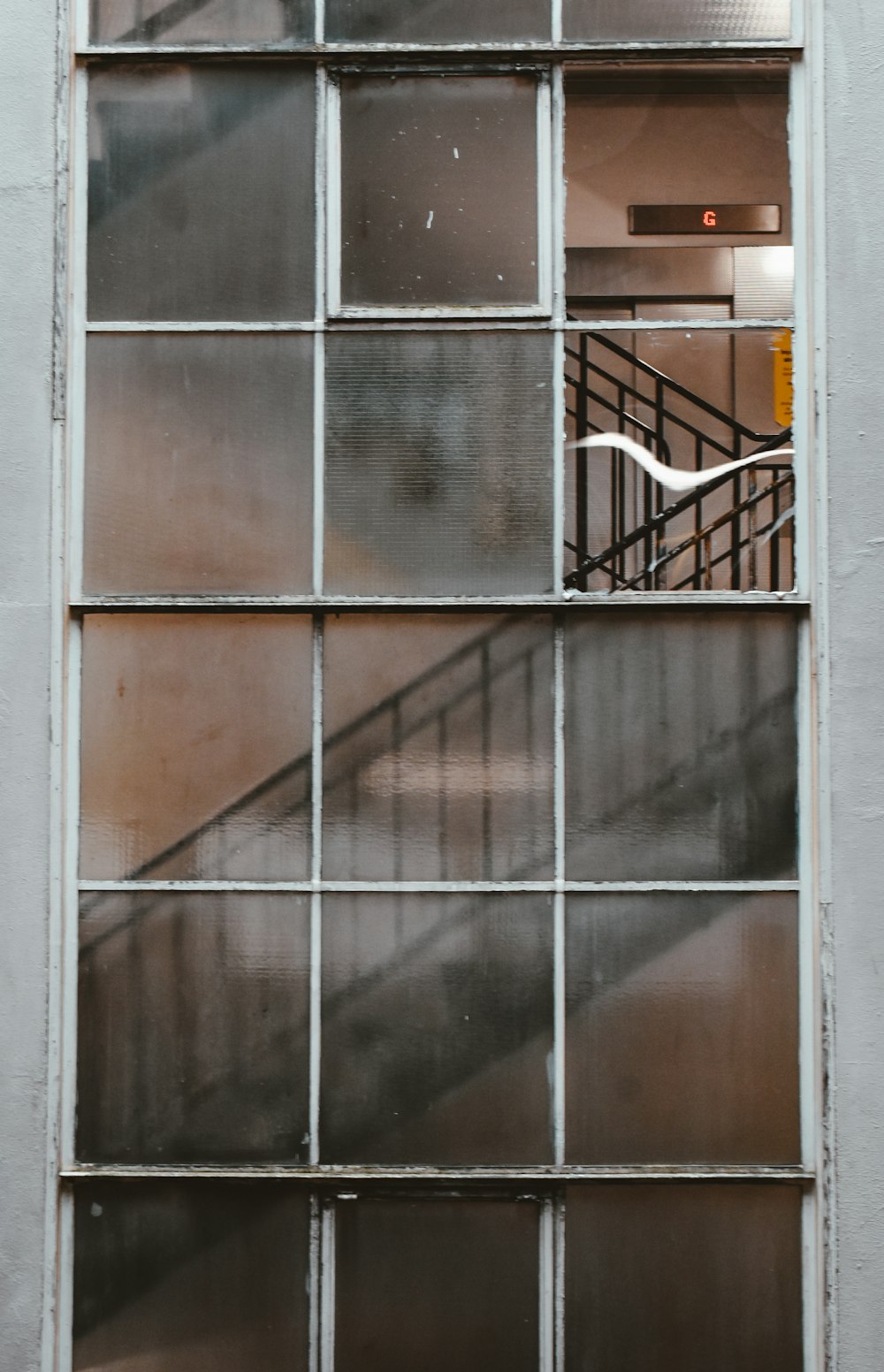 white metal framed glass window