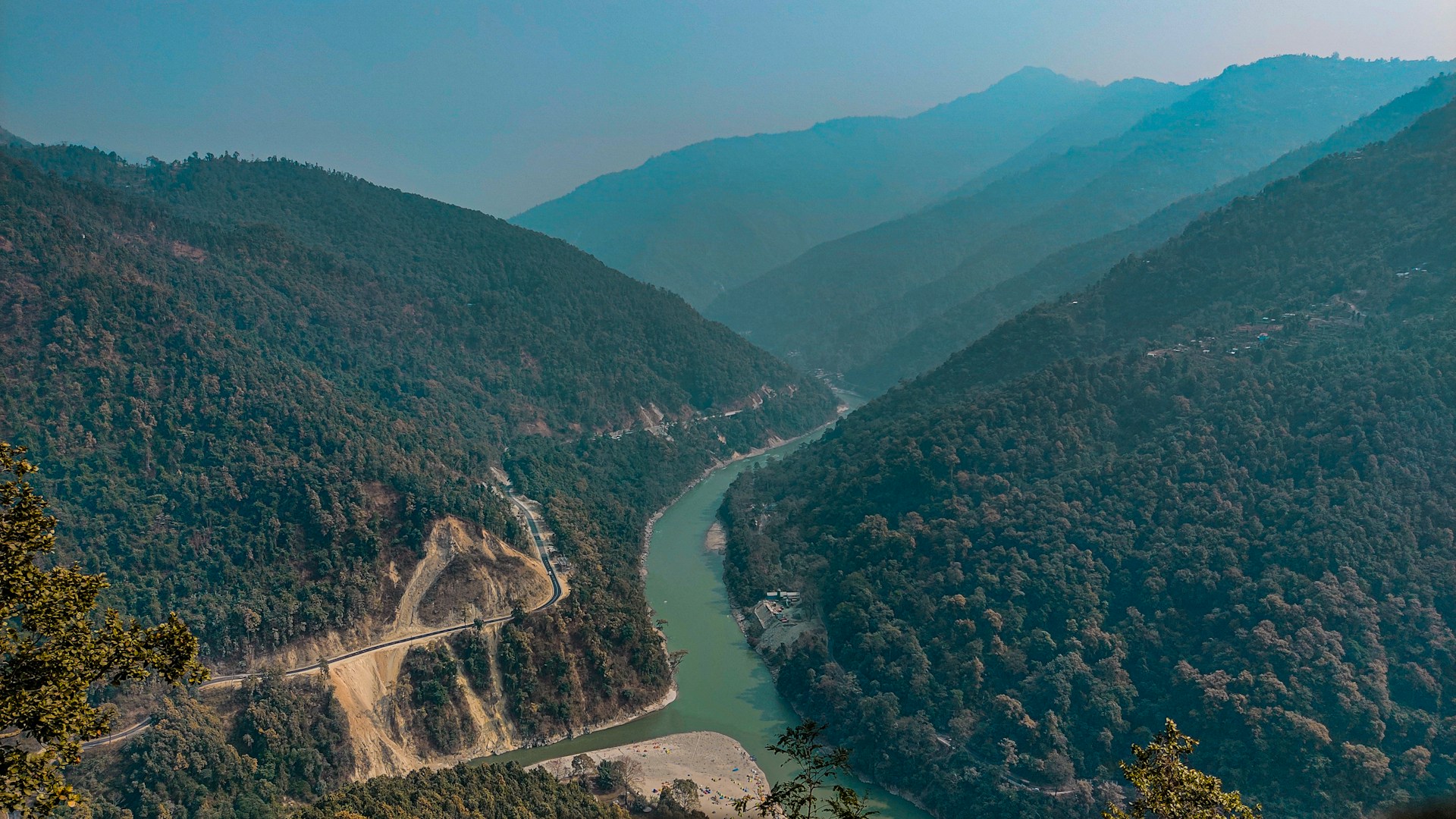 aerial view of green mountains and river during daytime