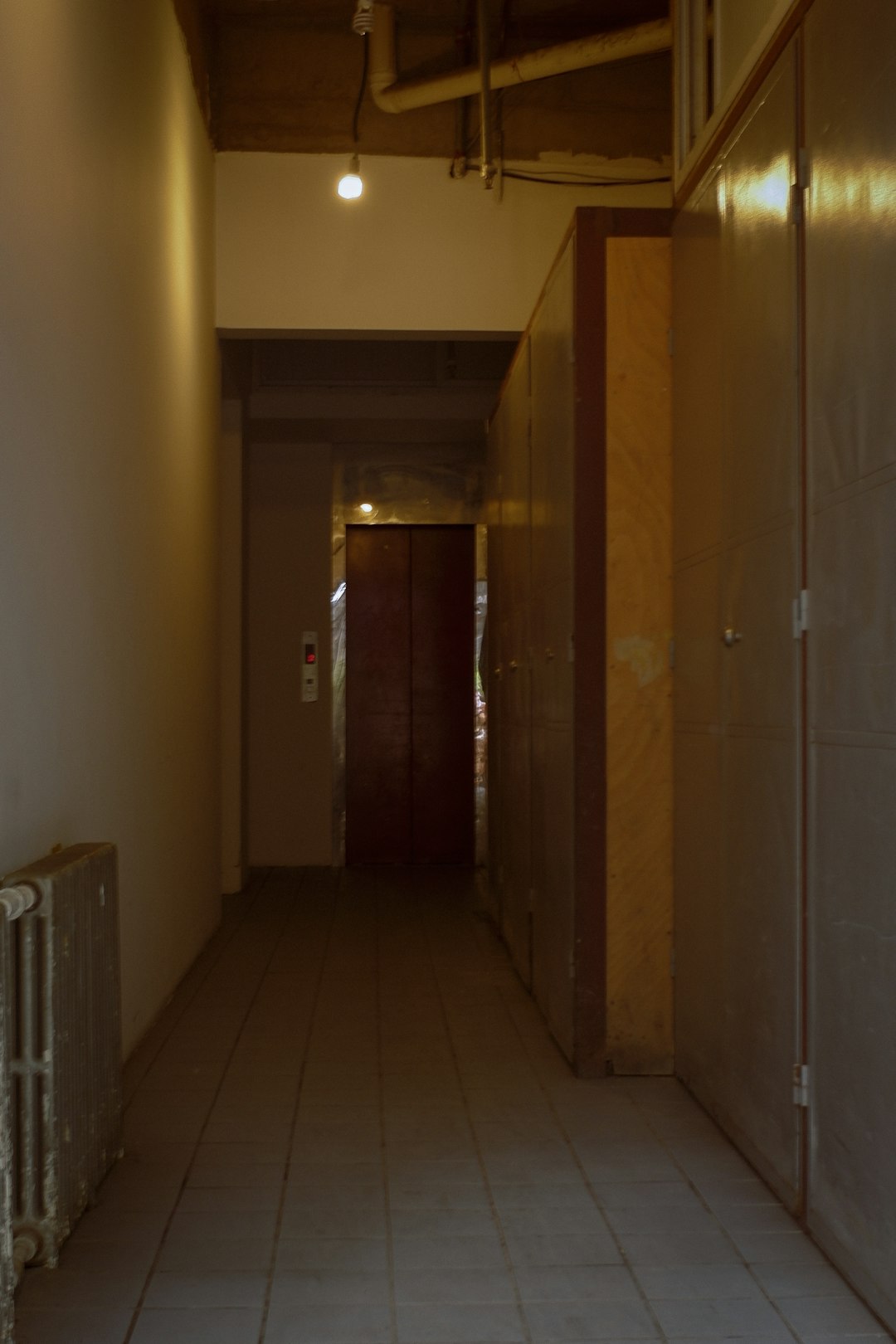 brown wooden door near white wall