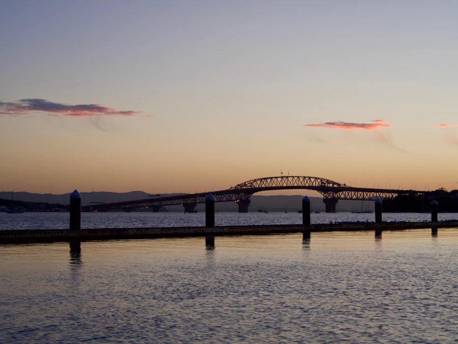 Auckland harbour at dusk, the bridge silhouetted against the water