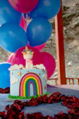 A vibrant theme cake featuring colorful fondant decorations for a kids' party.