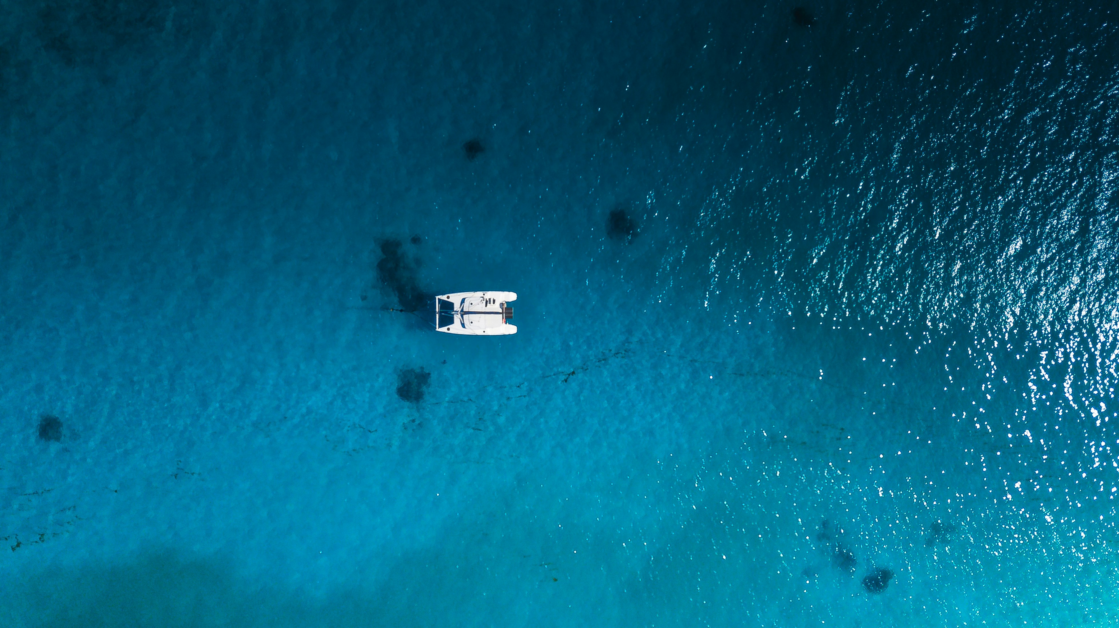white boat on body of water during daytime