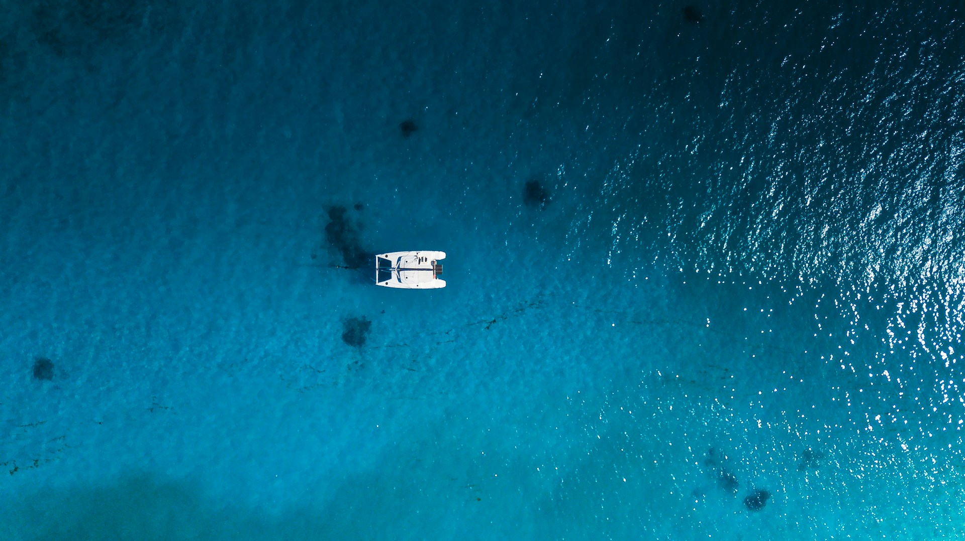 white boat on body of water during daytime