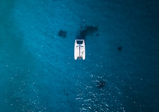 white boat on body of water during daytime