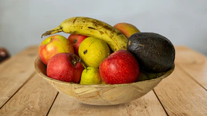 Fresh tropical fruits arranged on a wooden table.