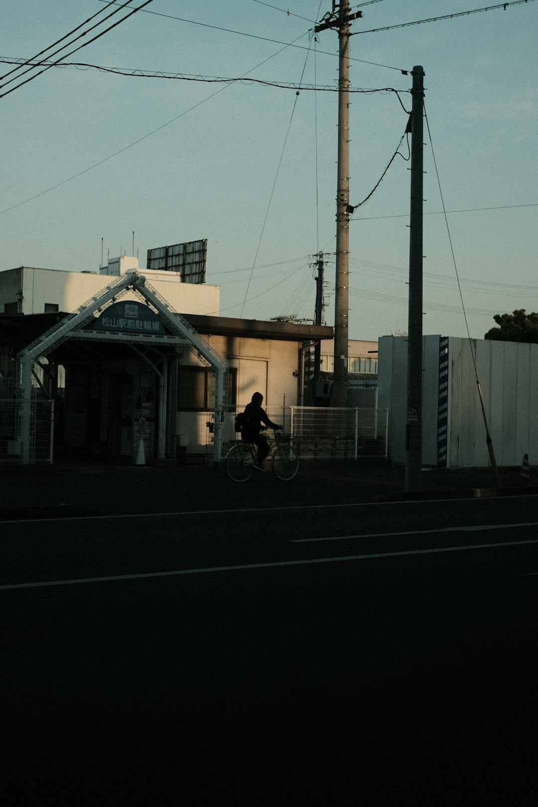 person riding bicycle near white building during daytime