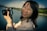 A happy customer posing with a beautiful landscape photograph.