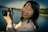 A happy customer posing with a beautiful landscape photograph.