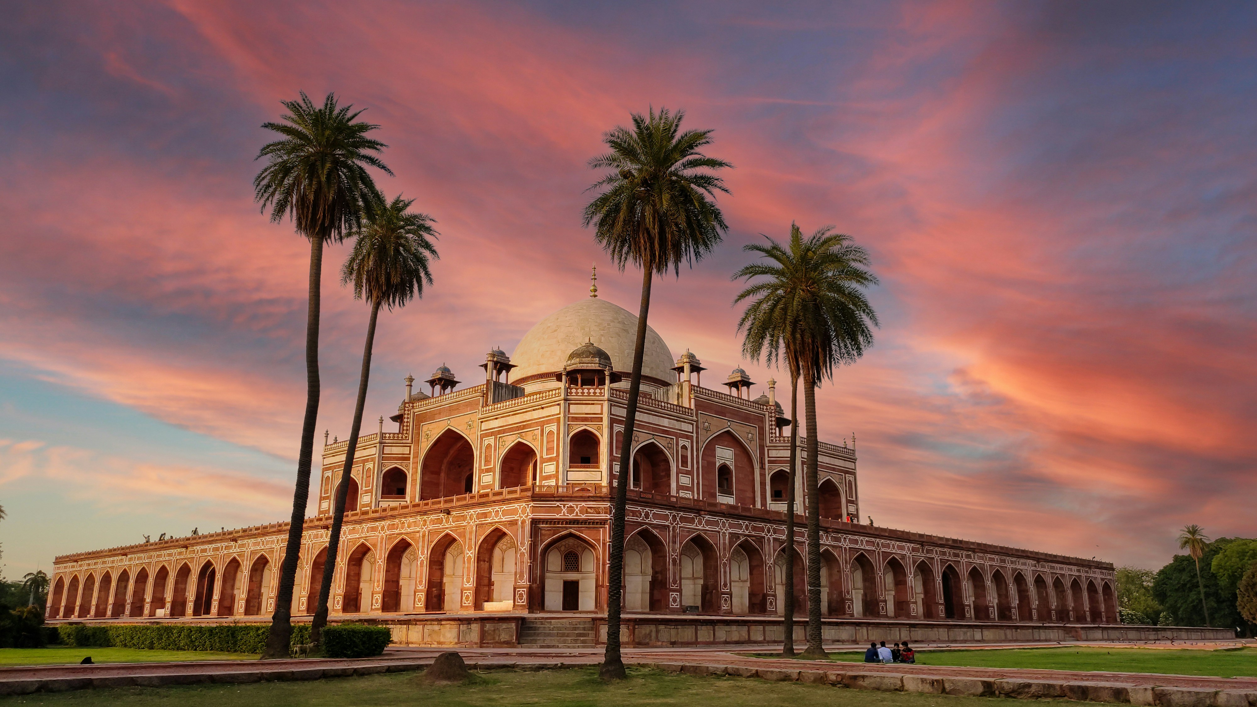 beige concrete building near palm trees during daytime