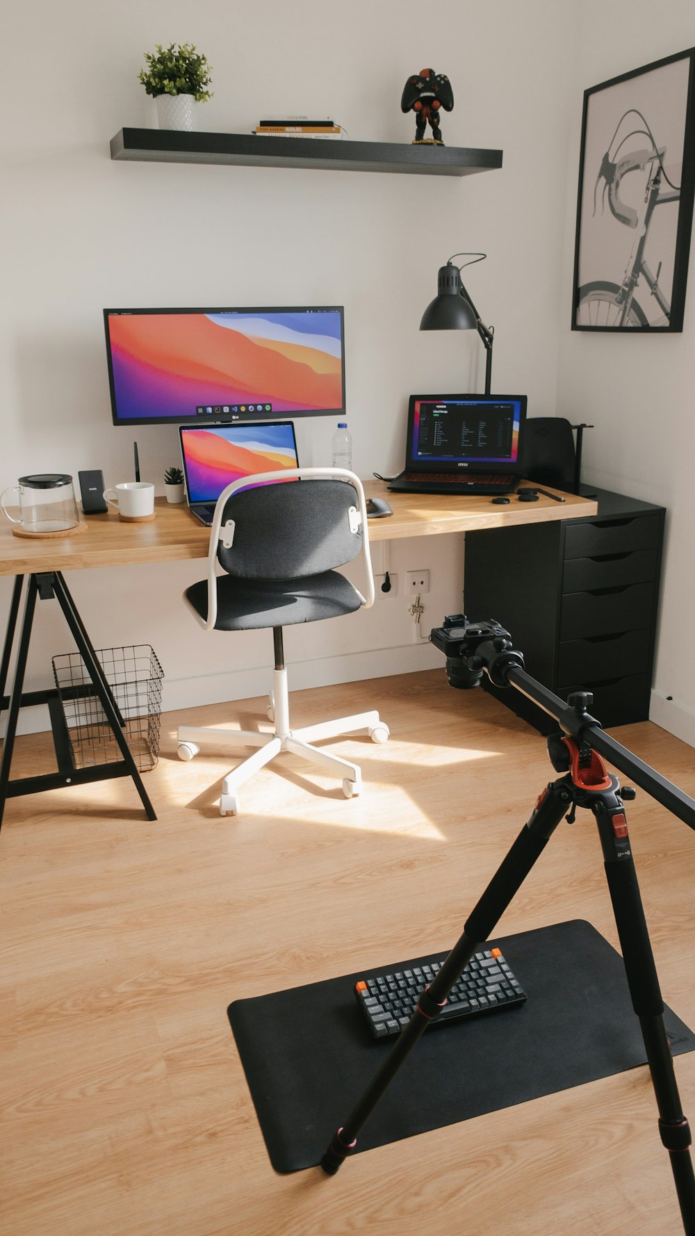 black and gray camera tripod on brown wooden table