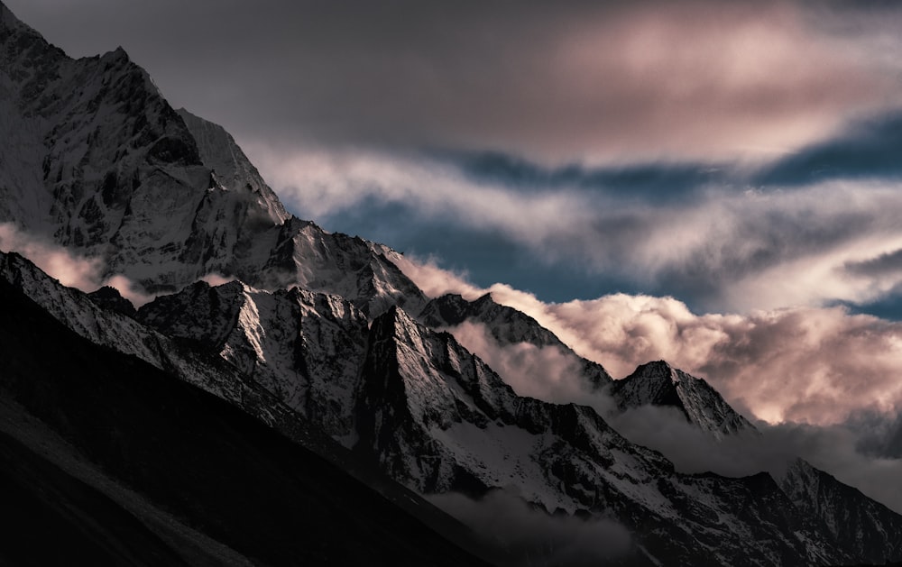 black and white mountains under cloudy sky during daytime