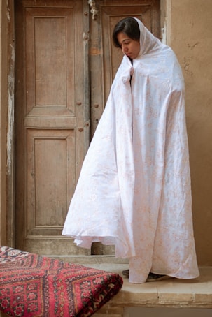 white robe on red and white bed linen
