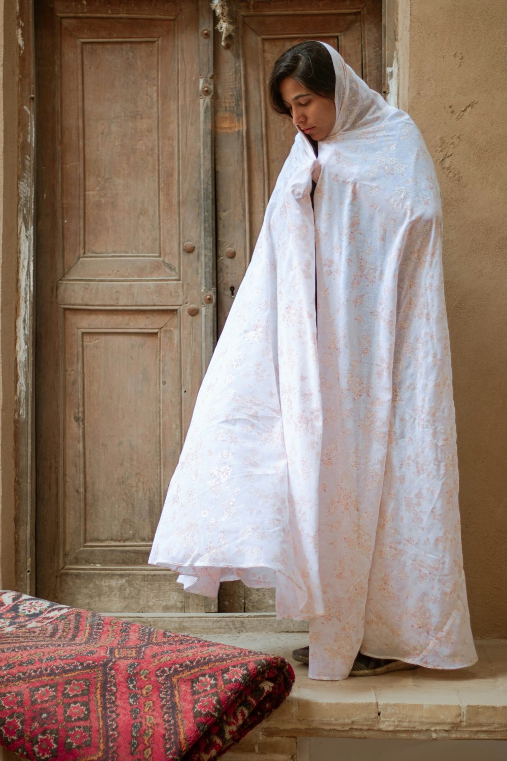 white robe on red and white bed linen