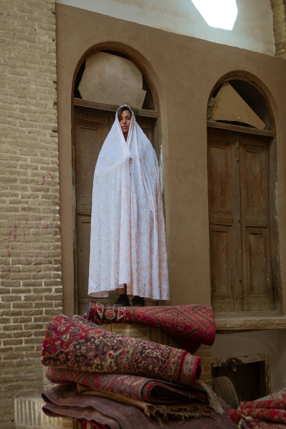 white robe hanged on brown wooden door