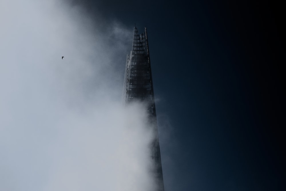 high rise building under white clouds