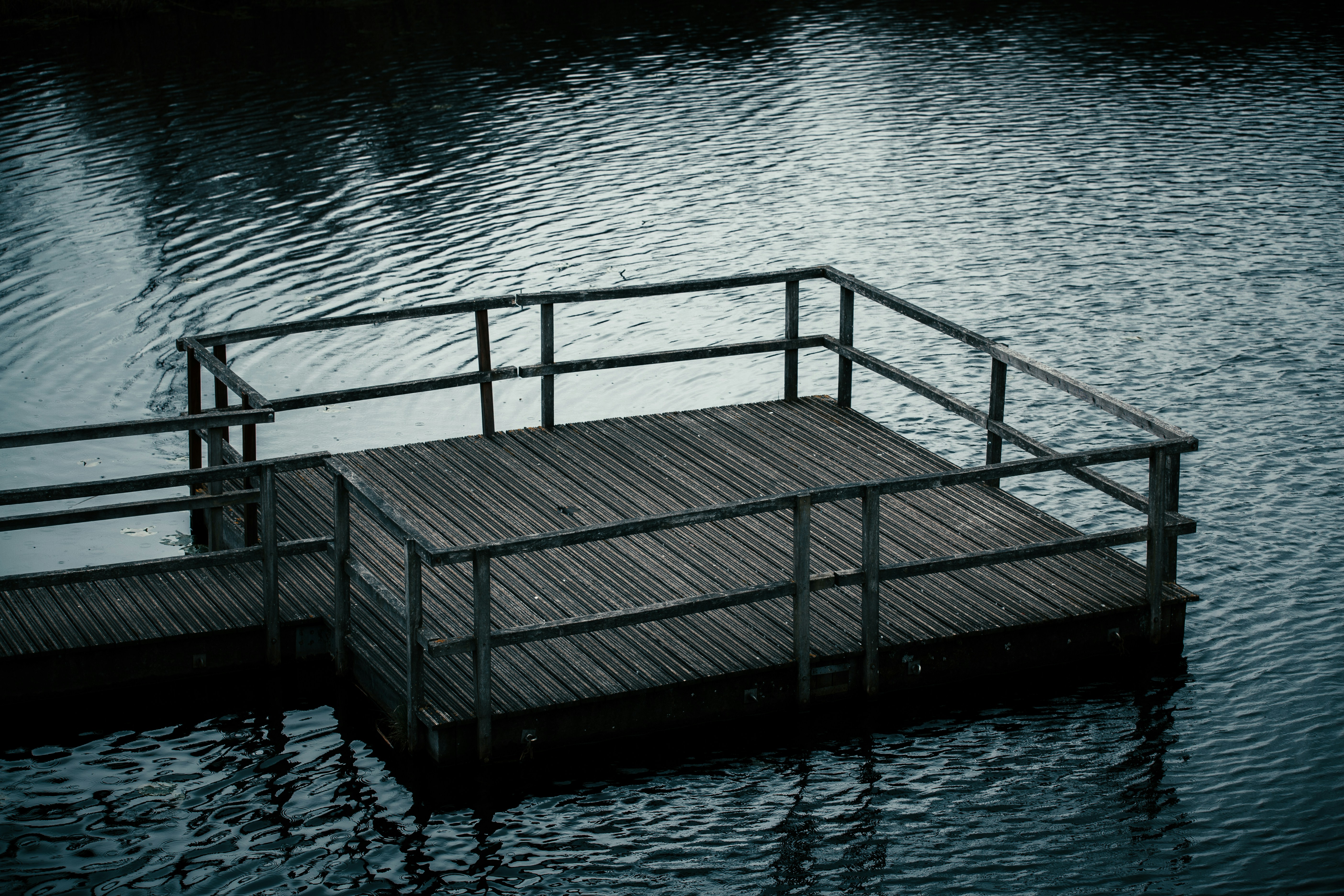 black wooden dock on body of water during daytime