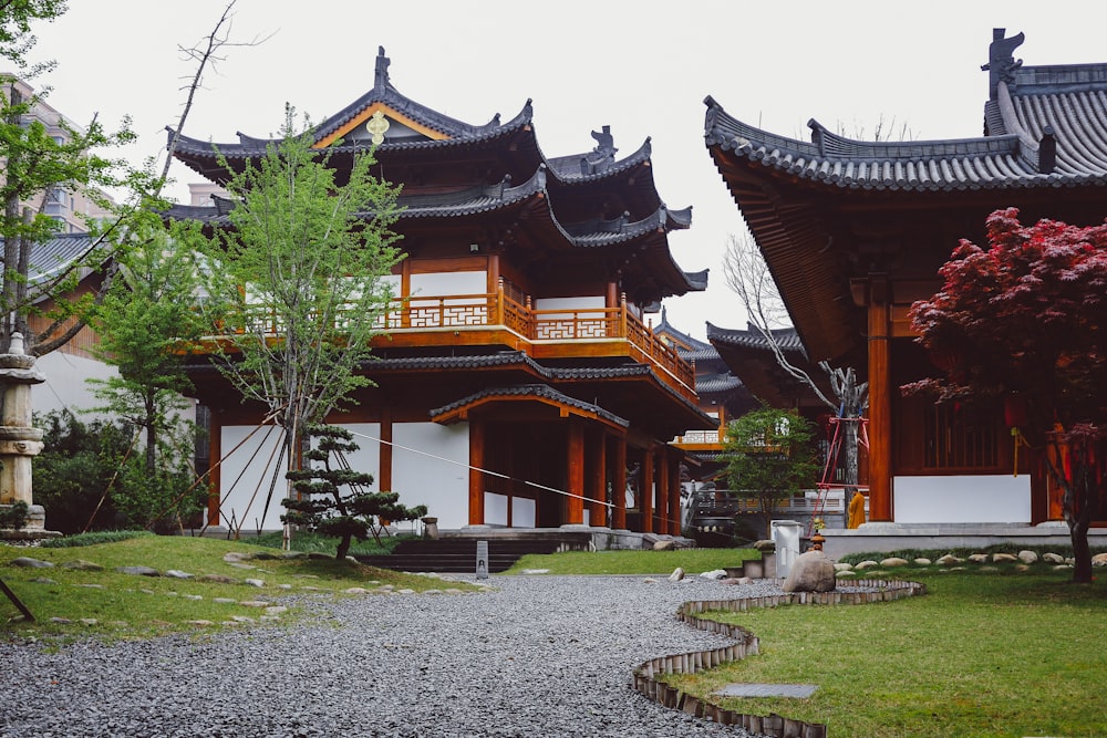 brown and white temple surrounded by green trees during daytime
