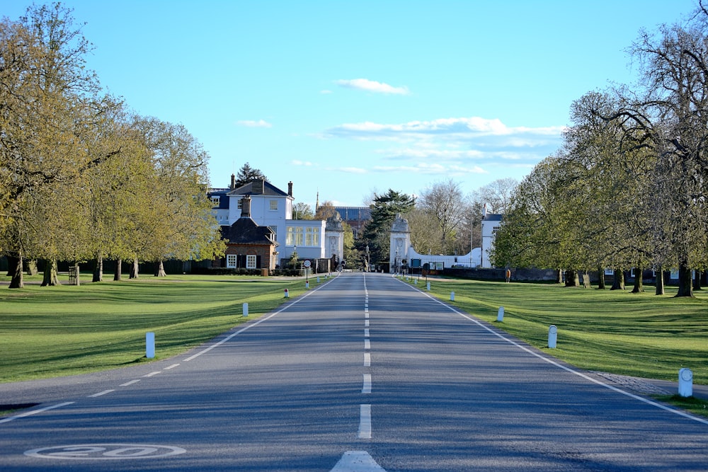 white and brown house near green grass field during daytime