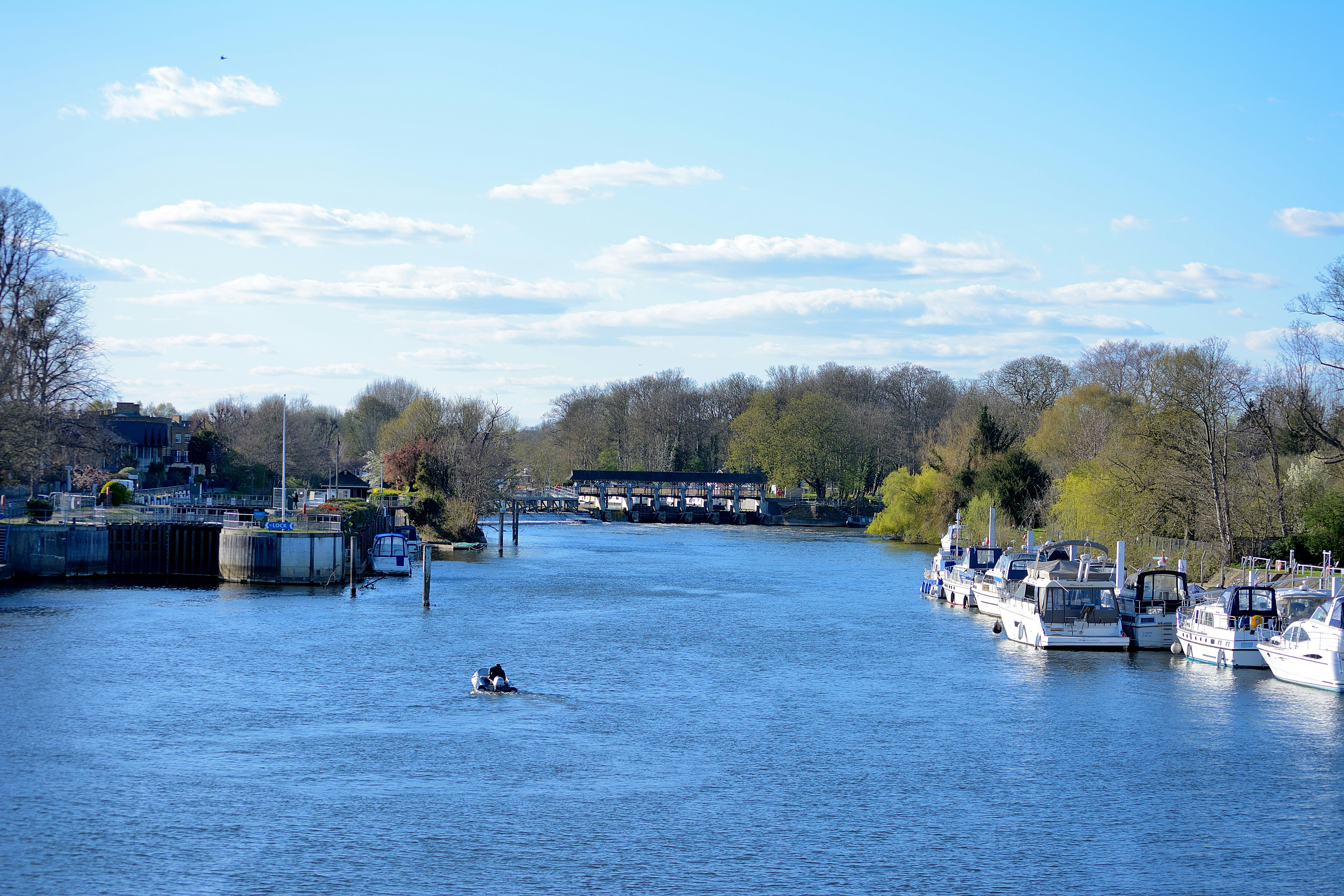 white boat on body of water during daytime, A photograph of Molesey Lock (left) on the River Thames taken from Hampton Court Bridge.