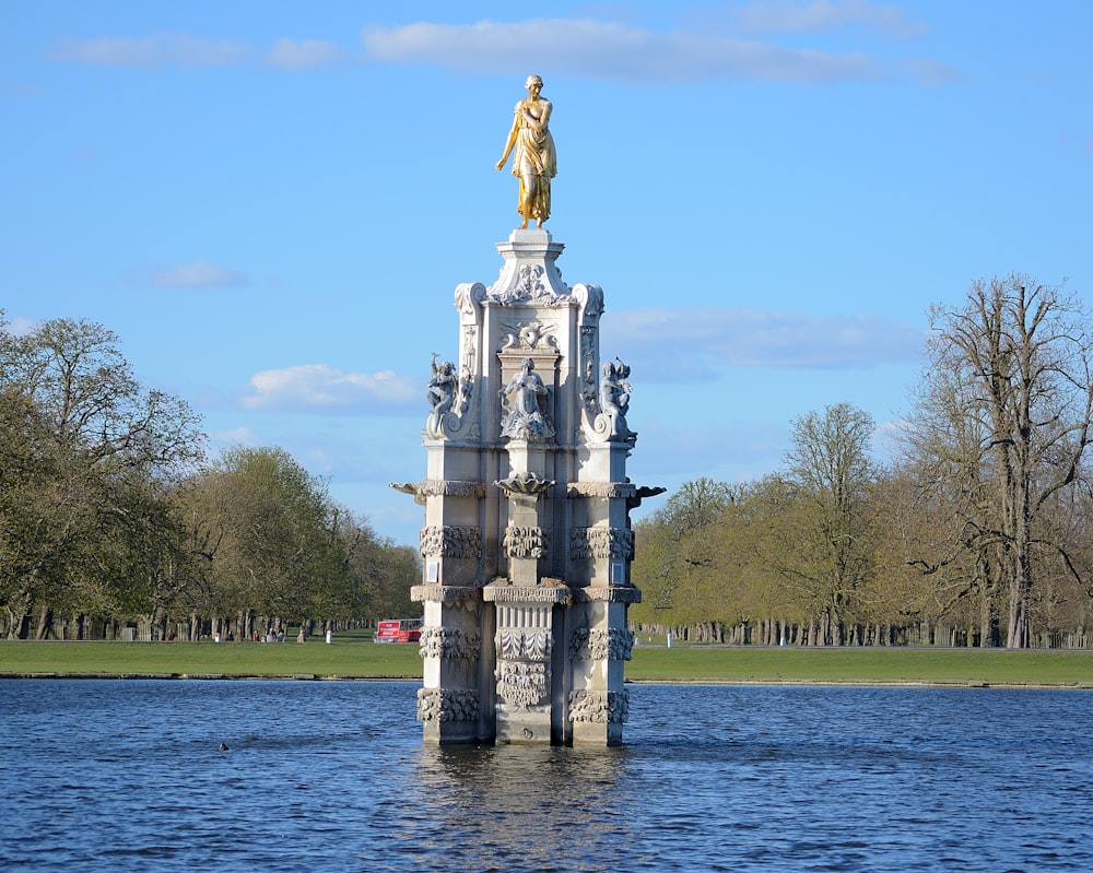 statue of man on water fountain