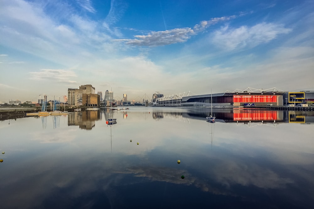 body of water near buildings under blue sky during daytime