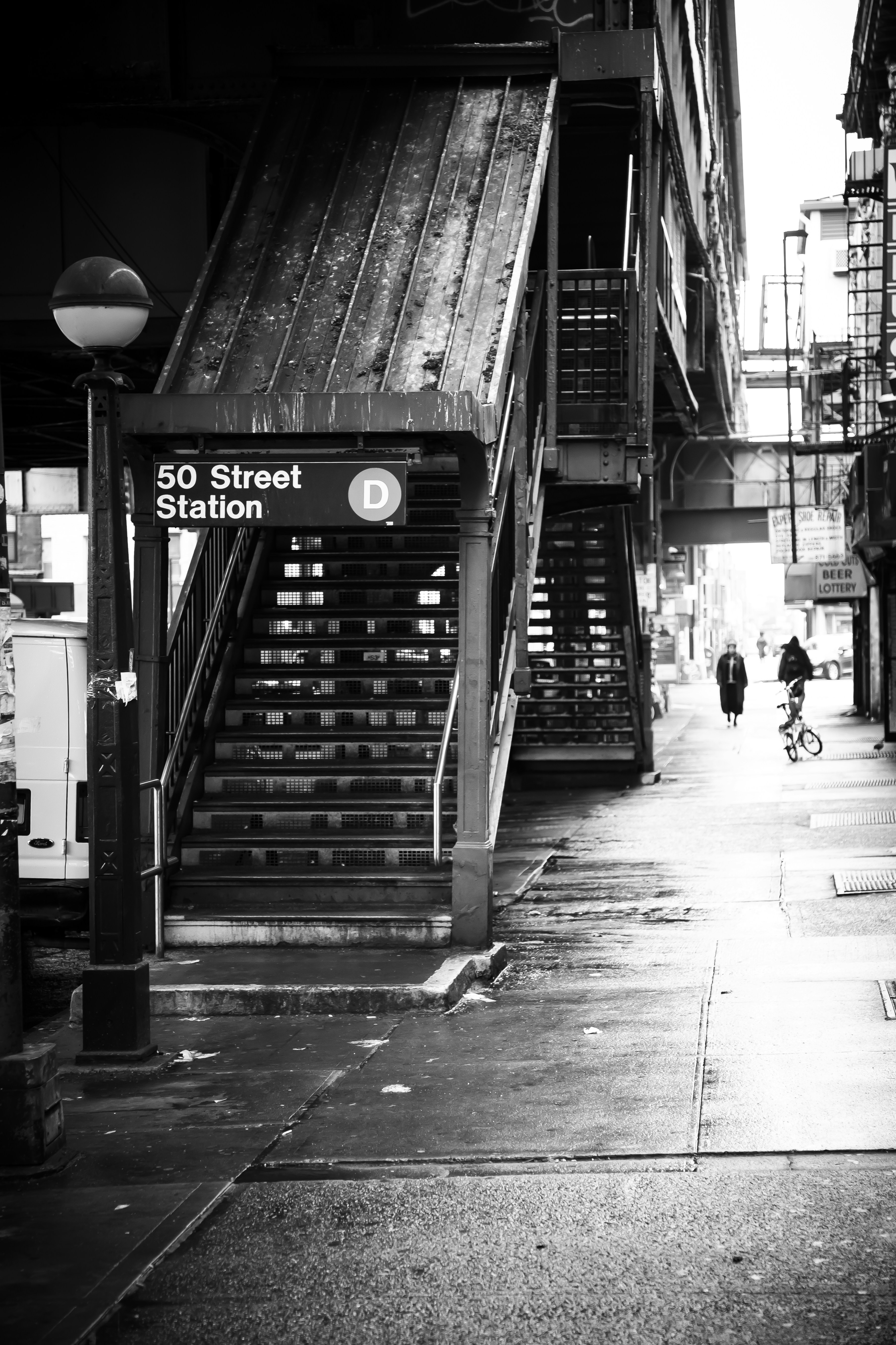 grayscale photo of people walking on sidewalk