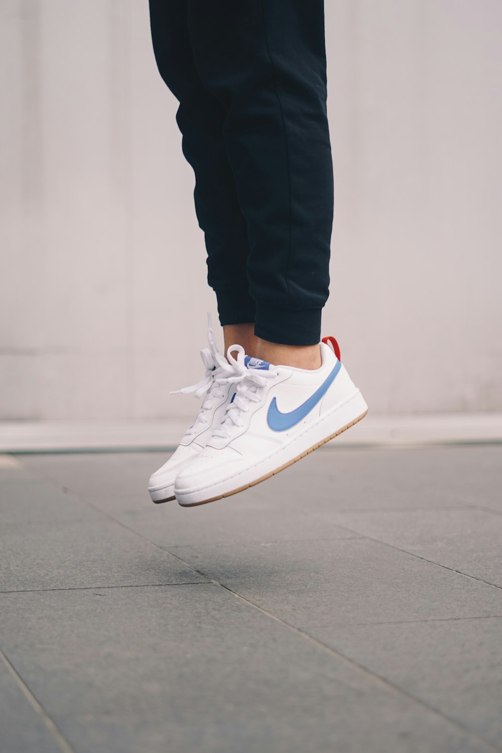 person in blue and white nike sneakers