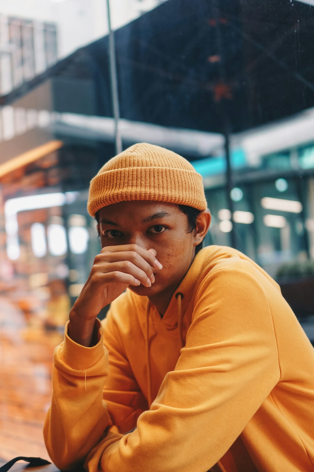 man in orange knit cap and yellow long sleeve shirt