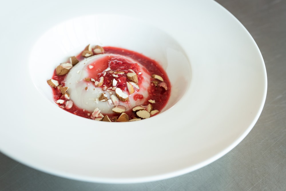 white ceramic bowl with red and white soup