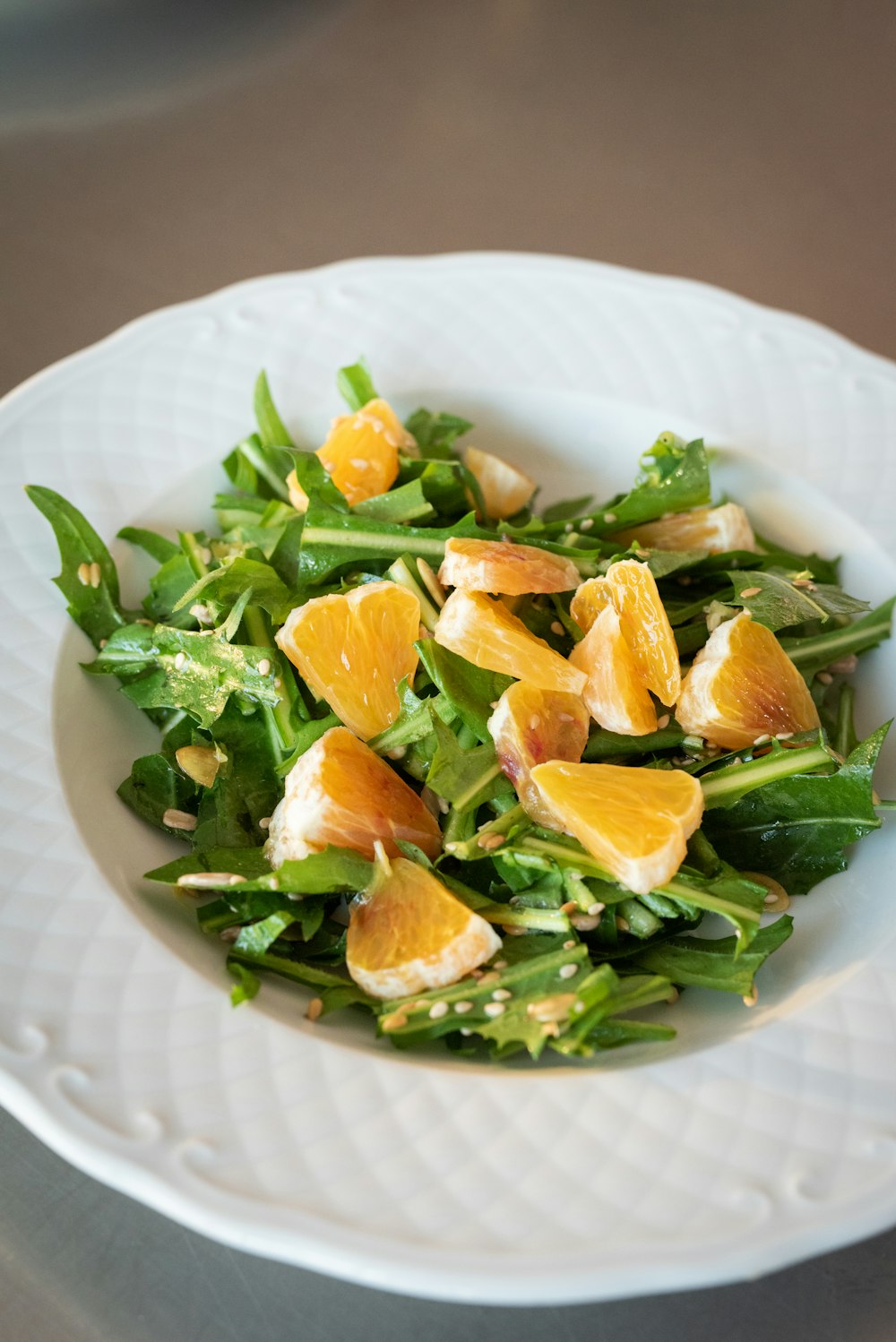 sliced orange fruits on white ceramic bowl