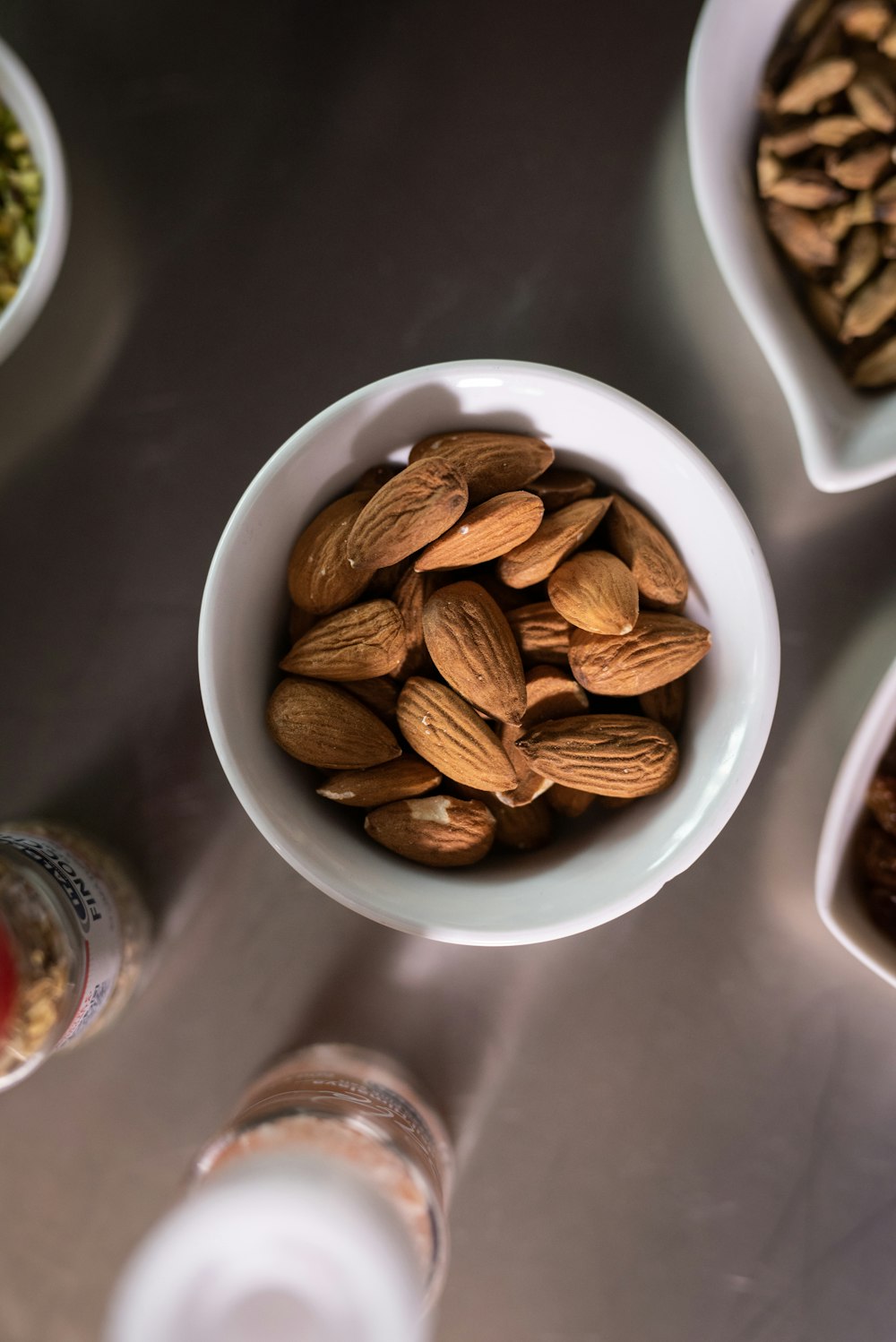 brown almond nut on white ceramic bowl