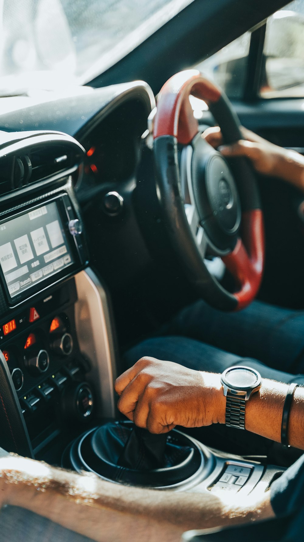 person holding black car stereo