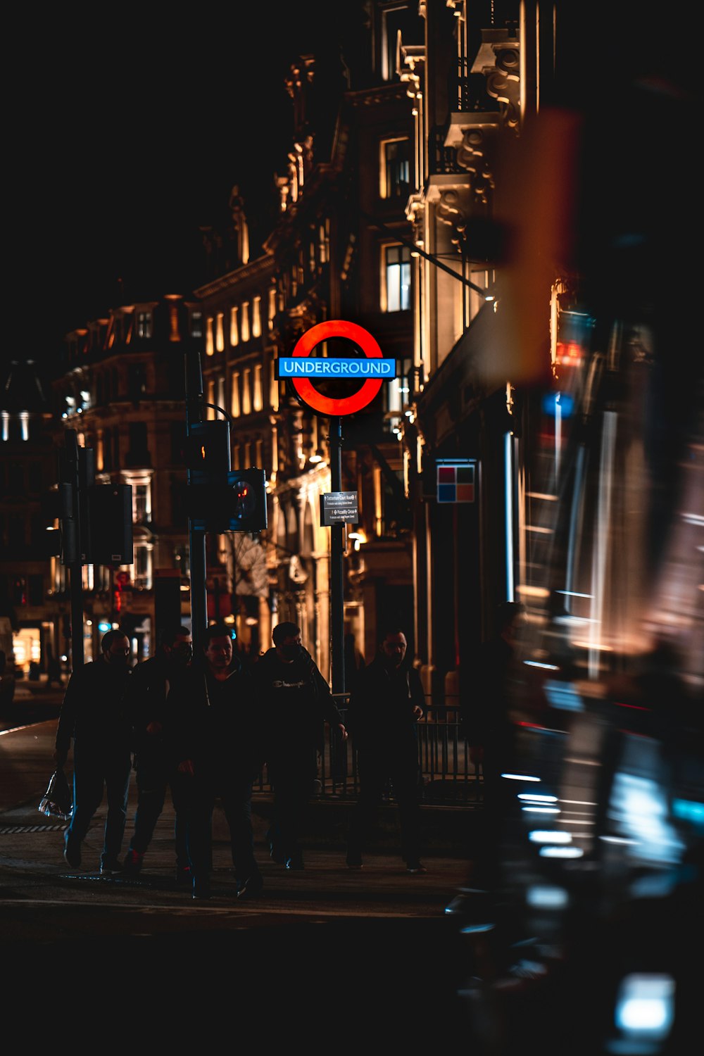 people walking on sidewalk during night time