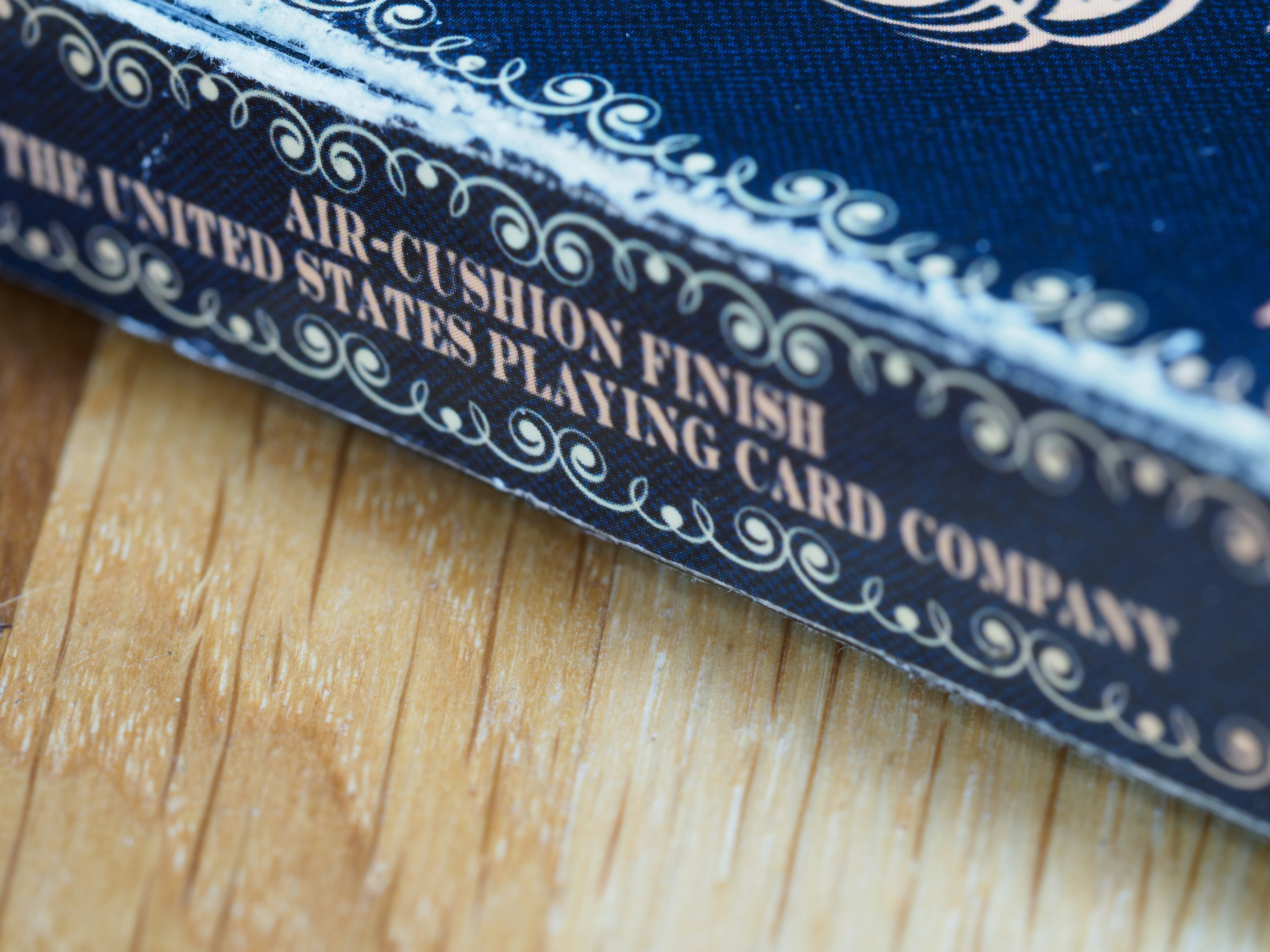 blue and white book on brown wooden table