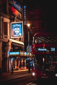 a red double decker bus driving down a street