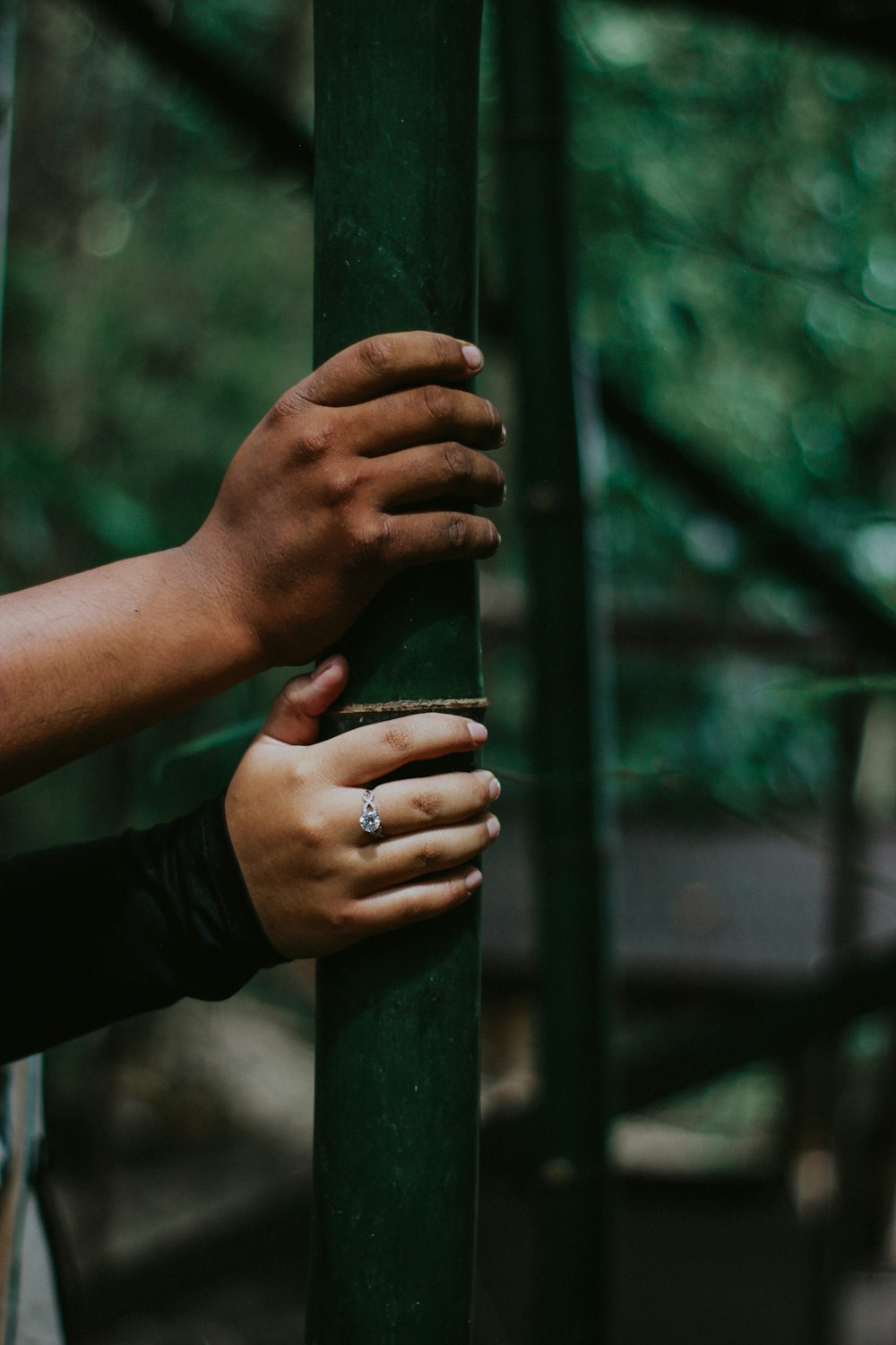 person holding green metal pipe